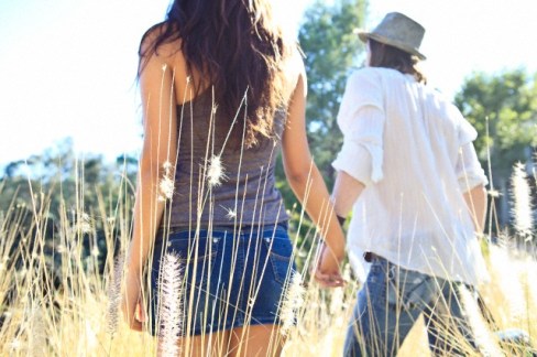 Young couple walking in field